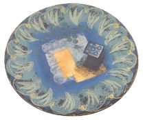 A terracotta studio pottery plate with i