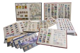 Plastic storage tub with low value ranges of lower value stamps in albums, loose,