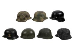 Eight reproduction army helmets. Includi