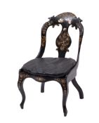 A Victorian parcel gilt and shell inset black papier-mâché side chair,