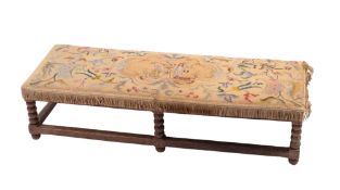 An oak and embroidery covered long stool,