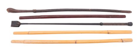 A mixed collection of horse tack, including stirrups, bits, crops and leatherwork etc.