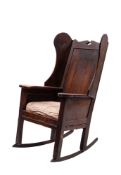 An oak wing back rocking chair,