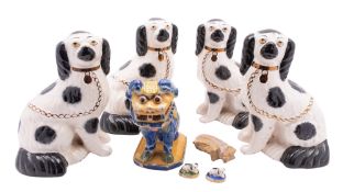A collection of ceramic animals comprising two late pairs of Staffordshire spaniels each with