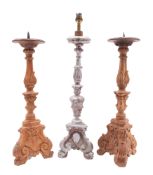 A pair of Italian carved pine pricket altar sticks in late 17th century style,