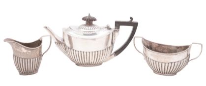 An Edwardian three-piece small or bachelor's silver tea set, oval form,