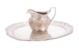 An Edwardian silver salver or tray, shaped circular outline,