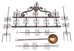A wrought iron wall hanging utensil rack,