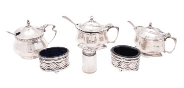 Mixed silver condiments, 3 mustard pots, 2 salts (blue glass liners), a mounted glass pepper caster,