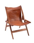 A tan leather and teak folding chair, in the manner of campaign furniture, circa 1960s; 75cm high,