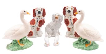 A pair of Staffordshire comforter spaniels, with painted liver patches,