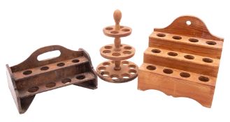 Three wooden egg stands, 20th century; comprising a stained walnut and softwood example,