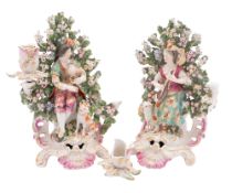 A pair of Derby porcelain figural bocage candlesticks modelled as a seated mandoline player with