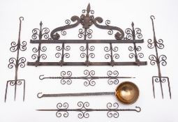 A wrought iron wall hanging utensil rack