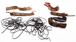 A quantity of leather bridles, some with