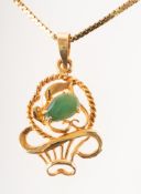 A green stone pendant with chain, the pendant in the form of an openwork basket,