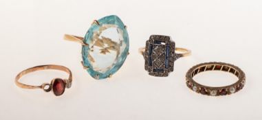 A small group of four rings of varied design,