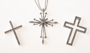 Three diamond set cross pendants of varied design,