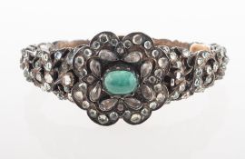 An antique green stone and paste set hinged bangle, possibly late Georgian,