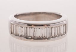 A baguette-cut diamond ring, of half eternity style, channel set with baguette-cut diamonds,