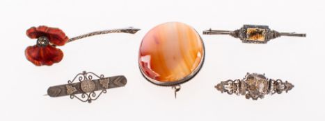 A group of five brooches, including a red enamelled poppy brooch set with marcasite,