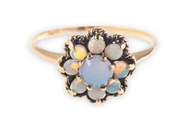 An opal ring, in the form of a flowerhead, claw set with opal cabochons,
