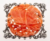 An antique carved coral plaque in a rose-cut diamond brooch mount,