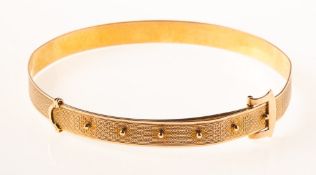An Art Deco 9ct gold buckle bangle / arm cuff, of belt and buckle design, engine turned engraving,