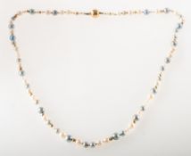 A freshwater pearl necklace, a string of knotted white and blue dyed freshwater pearls,