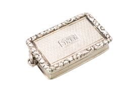A William IV silver vinaigrette, rounded rectangular, with an applied suspensory ring, reeded sides,