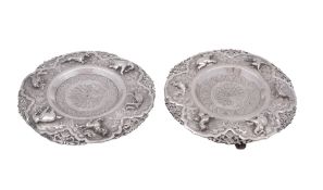 A pair of late 19th/ early 20th century Burmese silver stands, shaped circular outline,