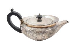 A George III silver tea pot, of squat circular form, with a 