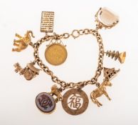 A charm bracelet with charms, the curb link bracelet