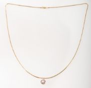 A snake chain and a collet set purple stone, a snake chain, lobster catch & chain ends marked 14k,