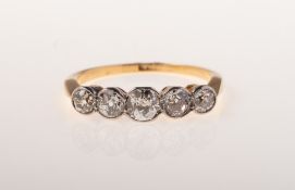 A five stone diamond ring, milgrain collet set with five graduated old-cut diamonds,