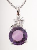 An amethyst and diamond pendant with chain, the pendant of foliate form,