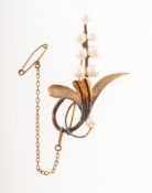 A flower spray pearl brooch, set with cultured pearls, the leaves having a textured pattern,