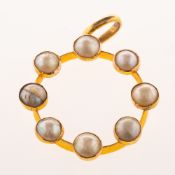 A pearl pendant, spaced and collet set around a circular frame with eight split pearls,