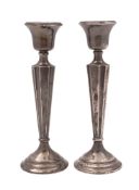 A pair of George V silver candlesticks, with circular bases (loaded),