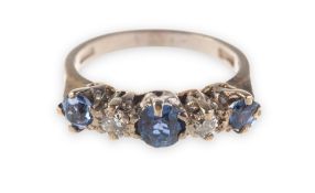 A sapphire and diamond five stone ring, claw set with three circular-cut sapphires,