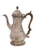 A George III silver coffee pot, of baluster form, with later embossed decoration,