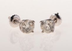 A pair of diamond stud earrings, each four claw set with a brilliant-cut diamond, diamonds approx.