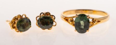 A green sapphire ring and a pair of green sapphire stud earrings,