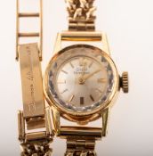 Girard-Perregaux an 18K gold lady's wristwatch the round silvered dial having raised baton numerals,