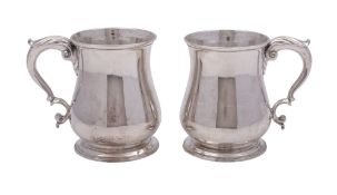 A pair of George II silver mugs, baluster form,