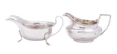A George III silver milk jug, squat circular form, with an angular handle and a gilt interior,