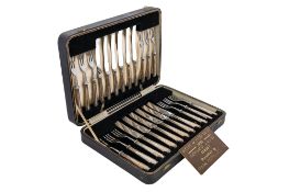 A George V cased set of six pairs of silver-handled dessert knives & forks, Ribbon & Reed pattern,