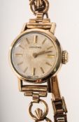 Longines a lady's gold-plated wristwatch the round silvered dial having raised baton numerals,