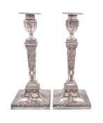 Two pairs of silver plated candlesticks,