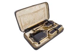 A George VI cased four-piece silver-gilt & tortoiseshell dressing table set,